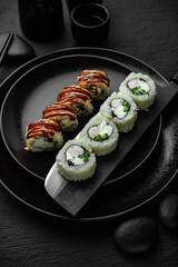 Panko roll with shrimp. Sushi composition on black background. The Art of Japanese Cuisine. Food photography for menu and sushi bar decoration