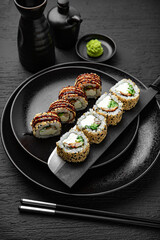 California Unagi Roll. Sushi composition on black background. The Art of Japanese Cuisine. Food photography for menu and sushi bar decoration