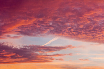 Bright orange clouds in the evening sky. A colourful sunset.