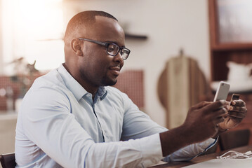 Credit card, phone and black man in home for online payment of mortgage loan and utility bills. Cellphone, financial budget and African male person with internet banking app for savings account.