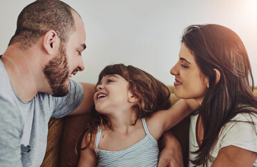Smile, girl and parents on couch with love for bonding, relationship trust and development in family home. Mom, dad and happy daughter on sofa with support for growth, calm weekend and relax together