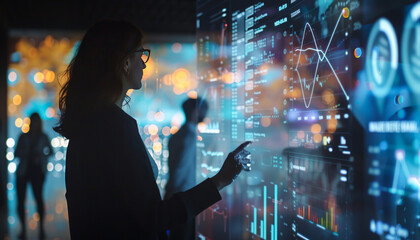 Obraz premium Write about a company that has integrated holographic data visualization into its daily operations. How do employees interact with the data? Describe a typical day in the office with this advanced tec