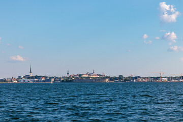 Tallinn silhouette from distance - sea side. Baltic sea Tallinn bay in front. Clear summer weather...