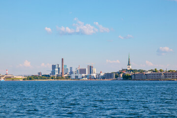 Tallinn silhouette from distance - sea side. Baltic sea Tallinn bay in front. Clear summer weather - July in Estonia.