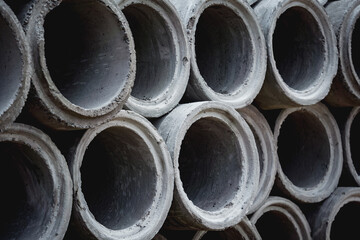 A stack of concrete ring pipes piled and creating a symmetrical arrangement