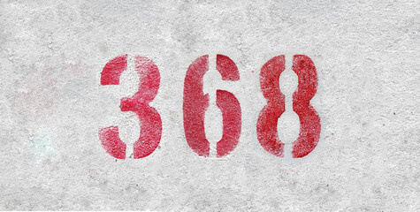 Red Number 368 on the white wall. Spray paint.