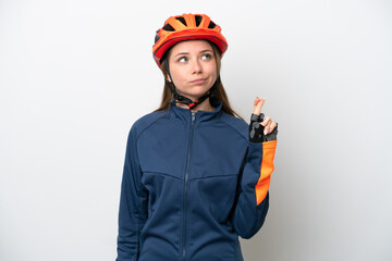 Young cyclist Lithuanian woman isolated on white background with fingers crossing and wishing the best
