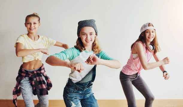Dance, fun and group of children in studio for hip hop rehearsal for concert show with music. Friends, rhythm and portrait of girls from Canada with groove for recital or performance at art school.