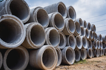 A stack of concrete ring pipes piled and creating a symmetrical arrangement