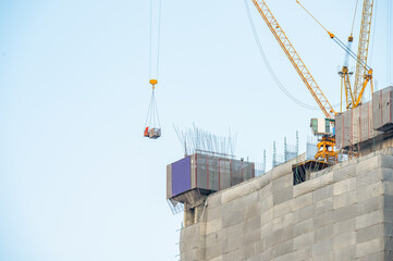 construction worker with crane. Hook cargo crane on the sky background. crane on a construction site