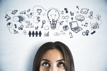 Woman looking up at hand-drawn business strategy and innovation icons on a white background,...