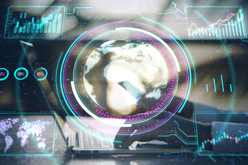 Digital interface displaying a holographic globe with various data charts, against a blurred office setting, concept of global business analytics