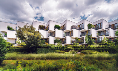 Green eco housing estate. Cubist minimalist modern architecture. Real estate urban plants.