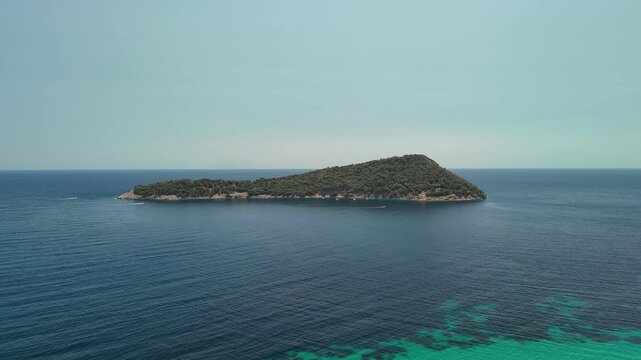 Aerial drone view of Nisida Kinira island in Greece in the summer season