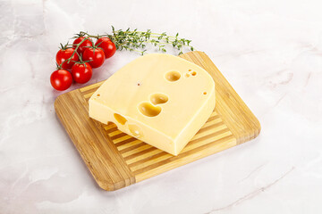 Maasdam cheese brick over board