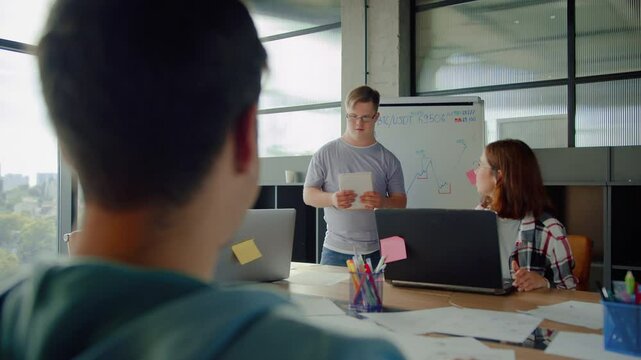 Person with developmental disability standing by white board