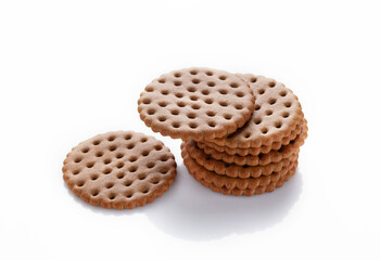 a stack of round ginger biscuits on a white background