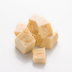 pieces of hard cheese on a white background