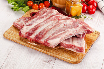 Raw pork ribs over board