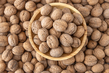 Walnut in shell. Background view from above. Healthy food bowl top view