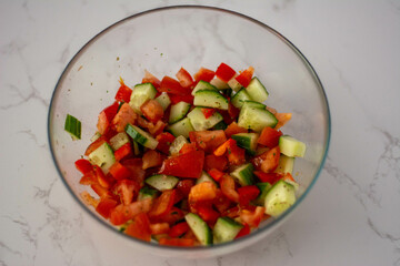 A fresh home-made salad with tomato and cucumbers 