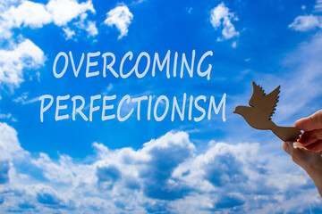 Overcoming perfectionism symbol. Concept words Overcoming perfectionism. Beautiful blue sky cloud...
