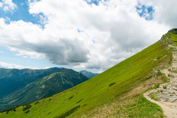 Beautiful mountain landscape with a mountain path. Hiking in the mountains in summer. Natural background. Tatra Mountains