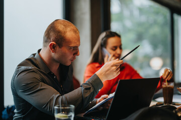 Focused young business entrepreneurs brainstorming and discussing strategy during a meeting in a modern office setting.