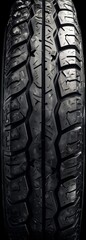 Extreme close up of a tire structure clean dry and glossy dark symmetrical frontal view sophisticated studio photography black background