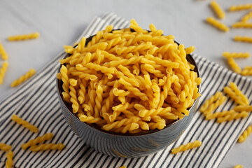 Homemade Raw Dry Gemelli Pasta in a Bowl, side view.