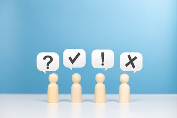 Wooden figurines standing speech balloon with question mark, exclamation mark ,True or False and...
