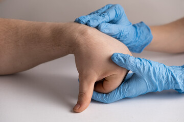 Ganglion cyst or hygroma of the wrist on the hand of a male patient, examination by a doctor