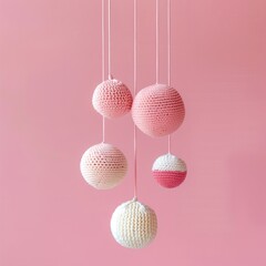 Baby crib mobile balls on pink background, knitted toy for children, hanging knitted balls