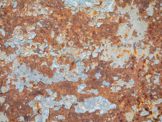 Rusty surface. Old metal with peeling paint. Rust on an uneven metal surface.