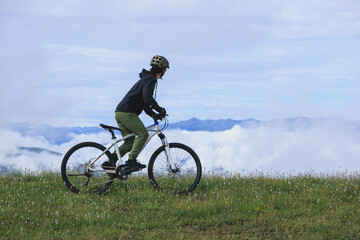 Riding mountain bike on beautiful mountain top