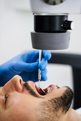 Operating dental digital microscope working process. Dentist uses operating microscope to polish...