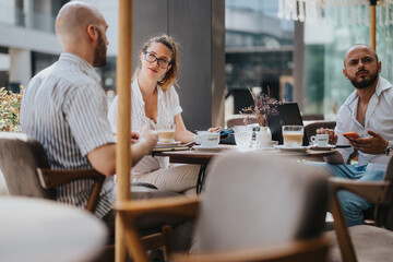 Startup team having a business meeting, brainstorming and strategizing ideas at a modern outdoor cafe setting