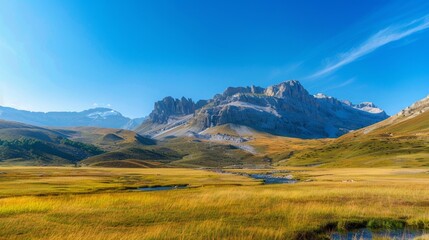 Fototapeta premium A serene mountain landscape with a clear blue sky in the background, promoting the idea of a healthy outdoor lifestyle. High quality images