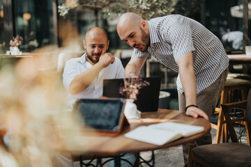 Two young business entrepreneurs strategizing and collaborating on a project, showcasing teamwork for improvement and growth.