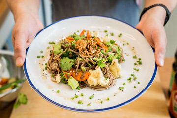 Japanese buckwheat pasta with lentils and vegetables in a bowl