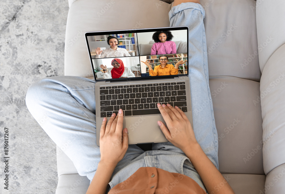 Poster an overhead view of a person sitting on a couch, using a laptop to video chat with four other people