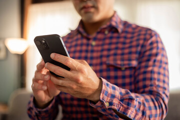 man using cell phone holding mobile texting message contact us.chatting,search internet shopping online.technology device communication connecting