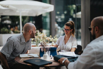 Young business entrepreneurs working together outdoors, discussing and brainstorming ideas for project improvement and growth.