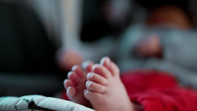 Close-up of baby&rsquo;s tiny feet in focus, relaxed infant in car seat, soft and tender toes, cozy and peaceful atmosphere, intimate and loving moment, detailed view of newborn feet, calm and comfortable
