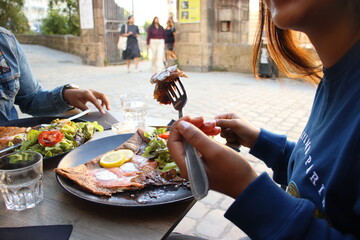 Enjoying Outdoor Brunch with Fresh Salad and Crepes