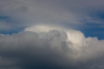 Obraz premium Formidable grey clouds in the sky before rain. Natural phenomenon gray clouds in the blue sky