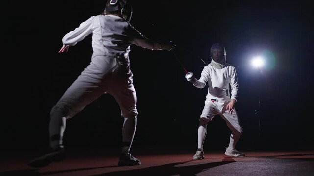 Rivals Fencers Fighting With Epees In Darkness, Fencing Track For Match And Training, Combat Sports