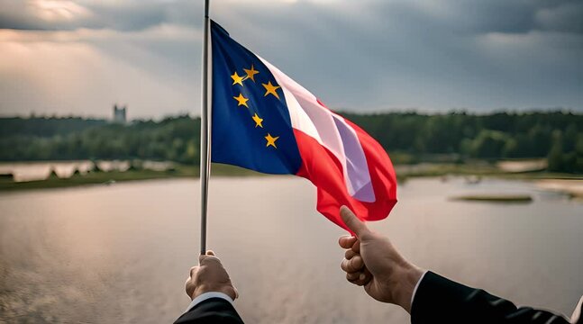 Flaga Polski i Unii trzymana w dłoni