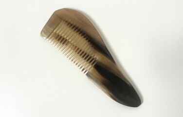 Gua sha Yak horn comb isolated on white background with copy space.