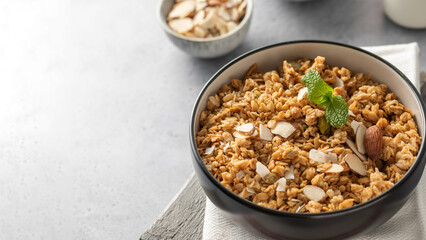 Crispy homemade granola with sliced almonds in a bowl. Healthy food. Copy space